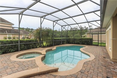Screen enclosed pool and spa with paver patio