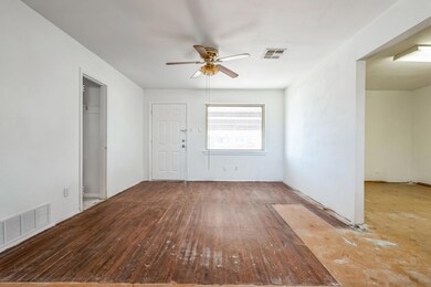 Spare room featuring ceiling fan, visible vents, a