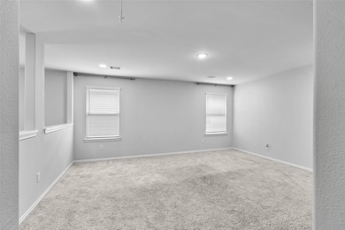This bright, spacious room features neutral carpet