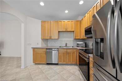 Kitchen with sink, backsplash, light brown cabinet