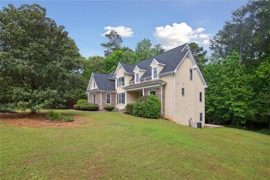 View of side of home featuring stucco siding, a ya