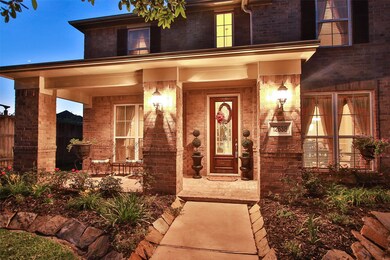 This stunning David Powers Home exudes curb appeal with the inviting front porch.