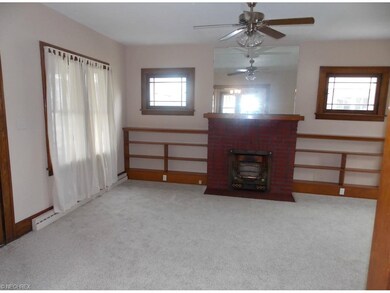 Living room with ceiling fan, leaded-glass windows