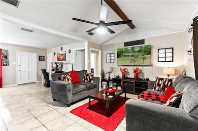 Living room featuring light tile patterned floors and a textured ceiling