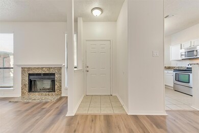 Tiled entrance foyer featuring a premium fireplace