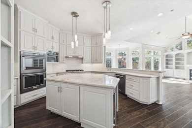 Stunning kitchen with double ovens, built in microwave, build in refrigerator and wine fridge in the island.