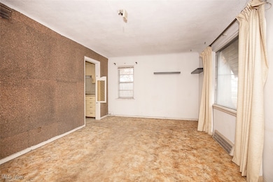 Spare room featuring baseboards