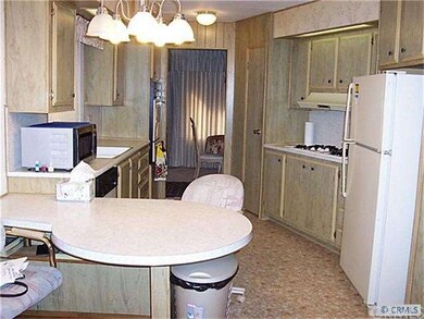 Well-lit Kitchen, with fridge, breakfast table, mi