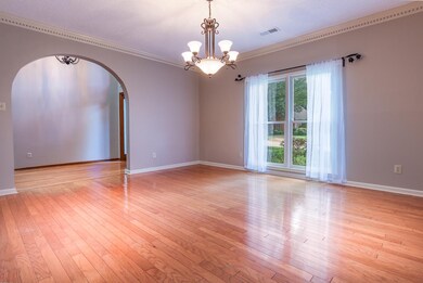 Large dining room with gleaming hardwood floors - 
