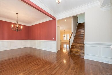 Foyer with wood flooring, wainscoting and heavy mo