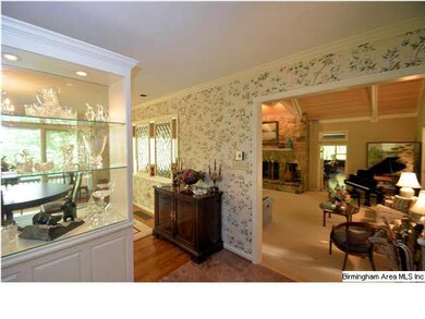 Foyer enters to formal dining behind hutch and gre