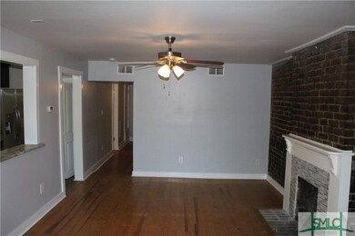 LIVING ROOM W/EXPOSED BRICK WALL AND MASONRY FIREP