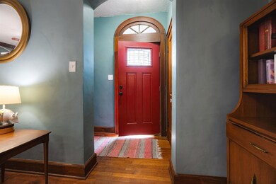 Entrance foyer featuring baseboards and wood finis