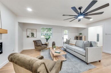 Living room with electric panel, light wood-type f
