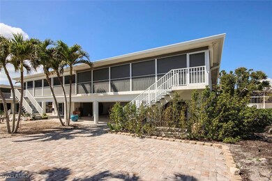 Rear view of property featuring a sunroom