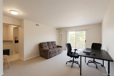 Office space featuring light colored carpet and baseboards