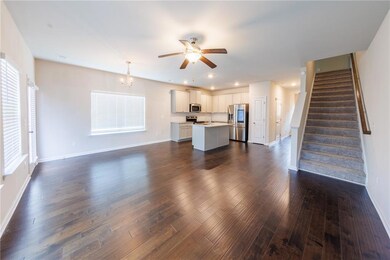 Unfurnished living room featuring a ceiling fan, stairway, dark wood finished floors, and recessed lighting