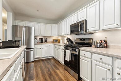 Kitchen featuring a sink, light countertops, appli