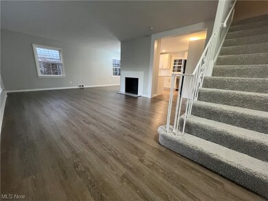 Unfurnished living room with dark hardwood / wood-style floors
