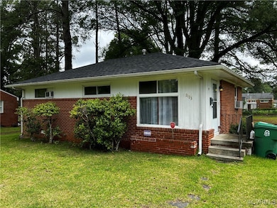 Bungalow-style home with brick siding, a front law