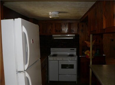 Kitchen with electric stove/oven and refrigerator. Both of these items remain with the home. 