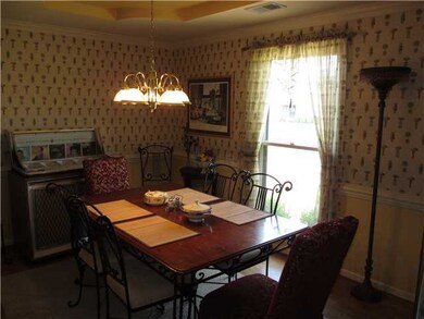 Dining Room has tray ceiling and wood floor.