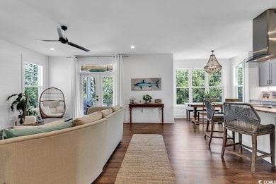 Living room featuring baseboards, recessed lightin