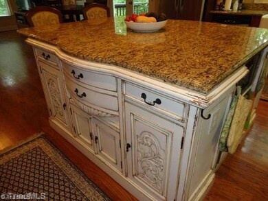 Kitchen. This closer at the island shows the detail of the custom island with granite countertop.  It also houses a wine cooler and microwave