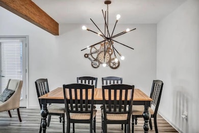 Dining room featuring beamed ceiling, wood finish