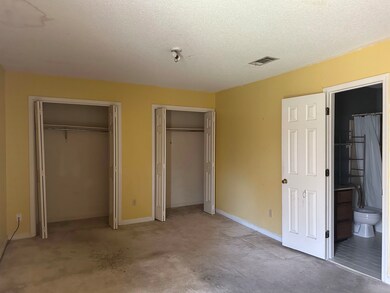 Unfurnished bedroom featuring a textured ceiling, 