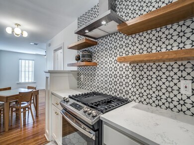 Kitchen with gas stove, visible vents, open shelve