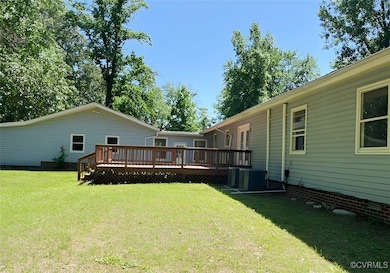 View of green lawn with a wooden deck and central