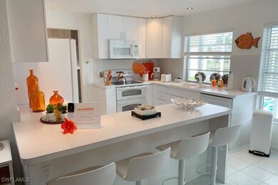 Kitchen featuring white appliances, a sink, a kitc