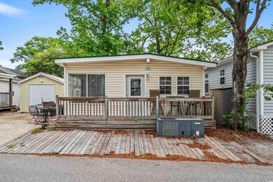 View of front of house featuring a deck, a shed, a