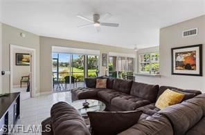 Living area featuring a ceiling fan and tile patterned floors