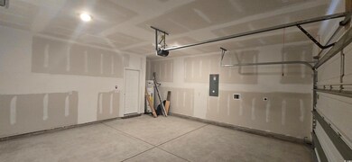 Garage with a garage door opener and electric panel