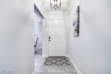Entryway featuring a notable chandelier and orname
