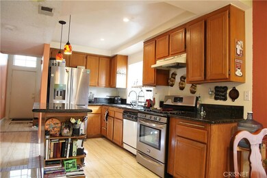 Open kitchen with built in stove and dishwasher
