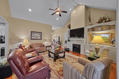 Living room featuring built in shelves, high vault