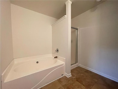 Full bathroom featuring a garden tub and a shower stall