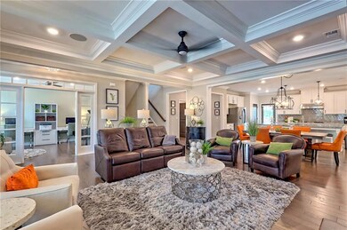Living area with crown molding, visible vents, sta