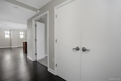 Corridor with baseboards and dark wood-type flooring