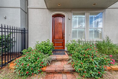 Charming entry with a solid wooden door, flanked b