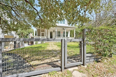 View of front facade with a fenced front yard and