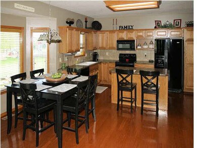 Large Open Kitchen with Wood Floors and Dining Are