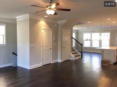 Unfurnished living room with crown molding, dark wood finished floors, ceiling fan, recessed lighting, and stairs