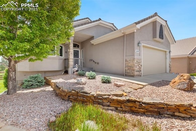 View of front of home with stucco siding, stone siding, concrete driveway, a garage, and a tiled roof