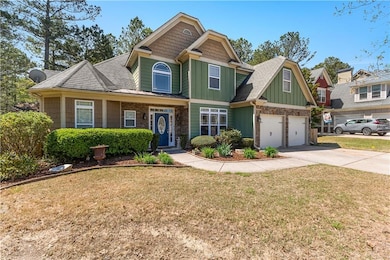 Craftsman house featuring a garage, driveway, boar