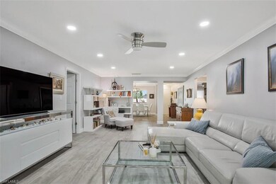 Living room featuring ceiling fan, light wood-type