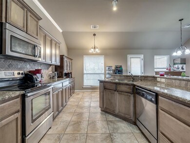 Kitchen featuring sink, a notable chandelier, hang